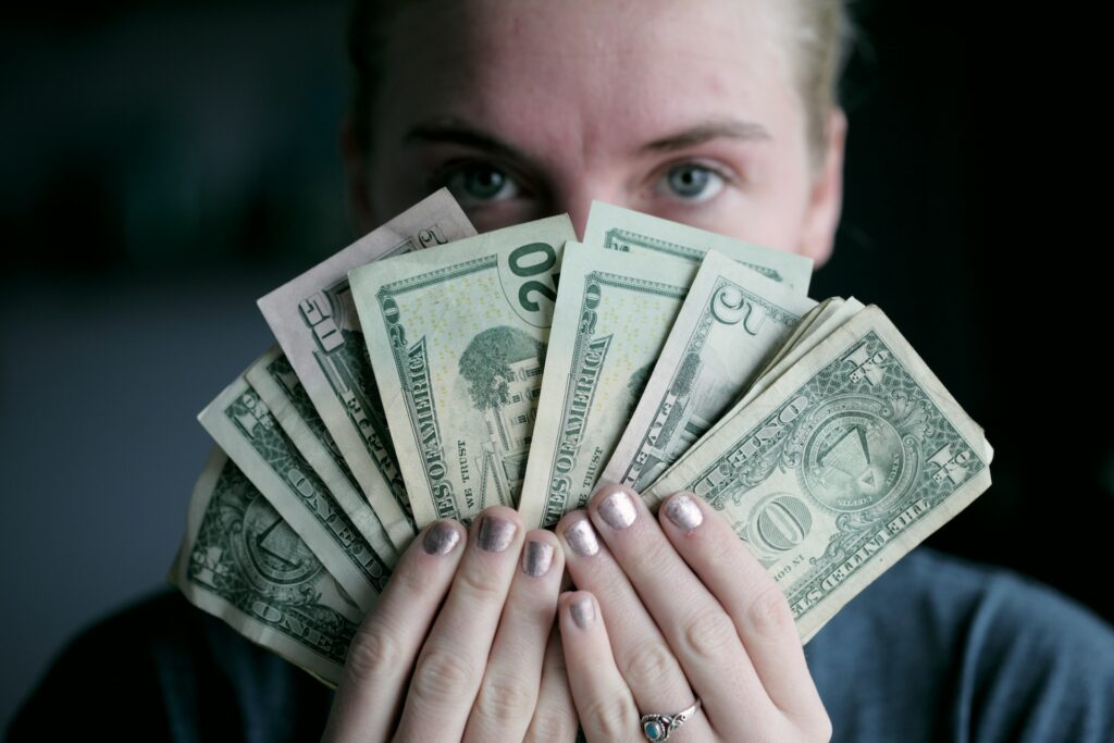 man holding dollar bill